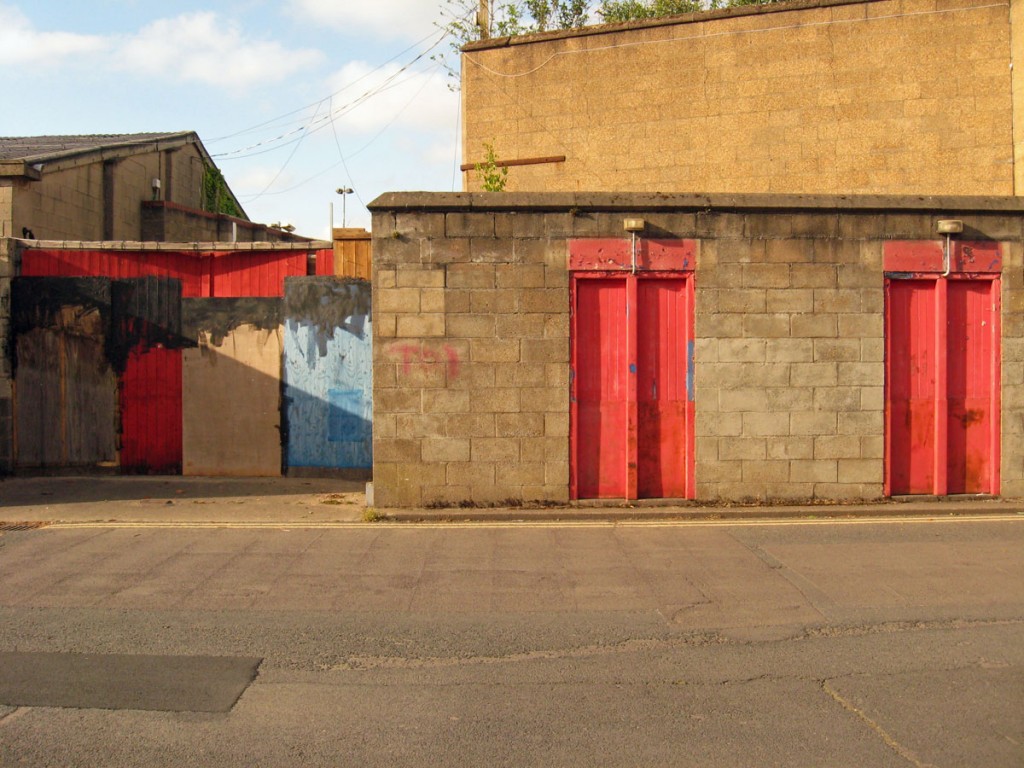 Red and blue painted gates in concrete block walls