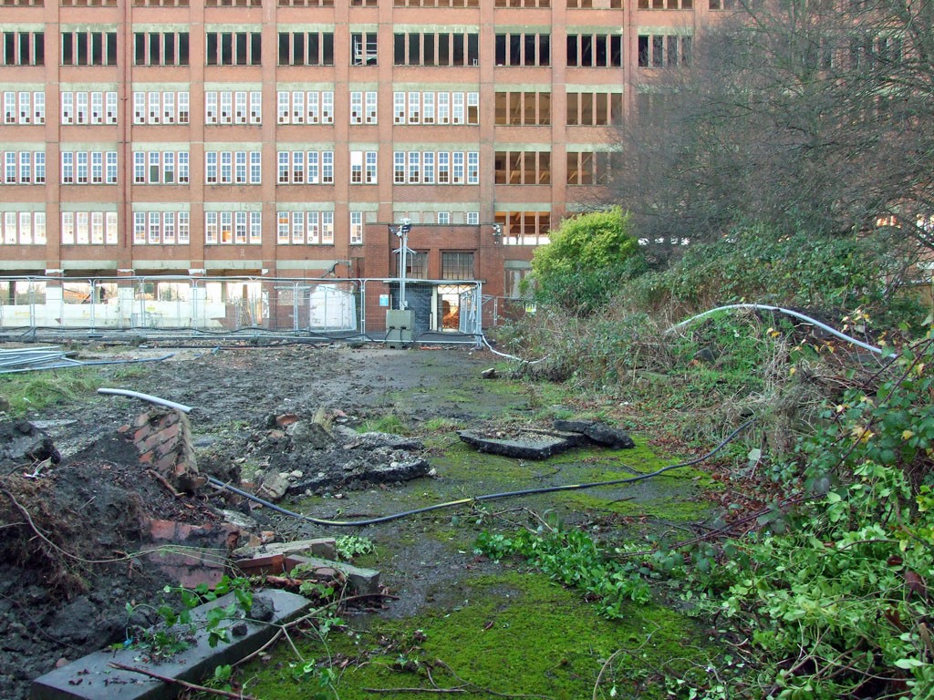 Rubble and moss with factory entrance behind