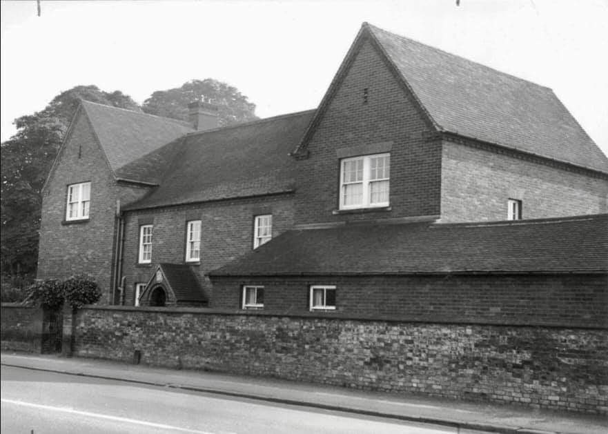 Black and white photo of substantial house