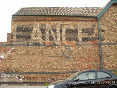 Old faded painted sign on brick wall