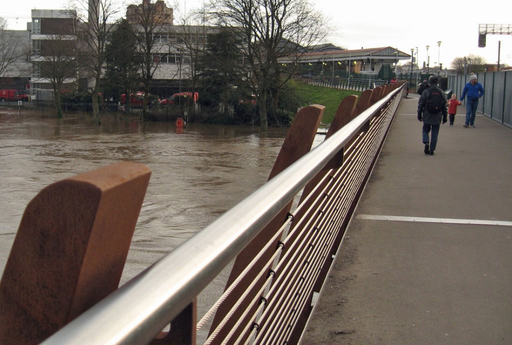 Bridge, with pedestrians, flooded river below