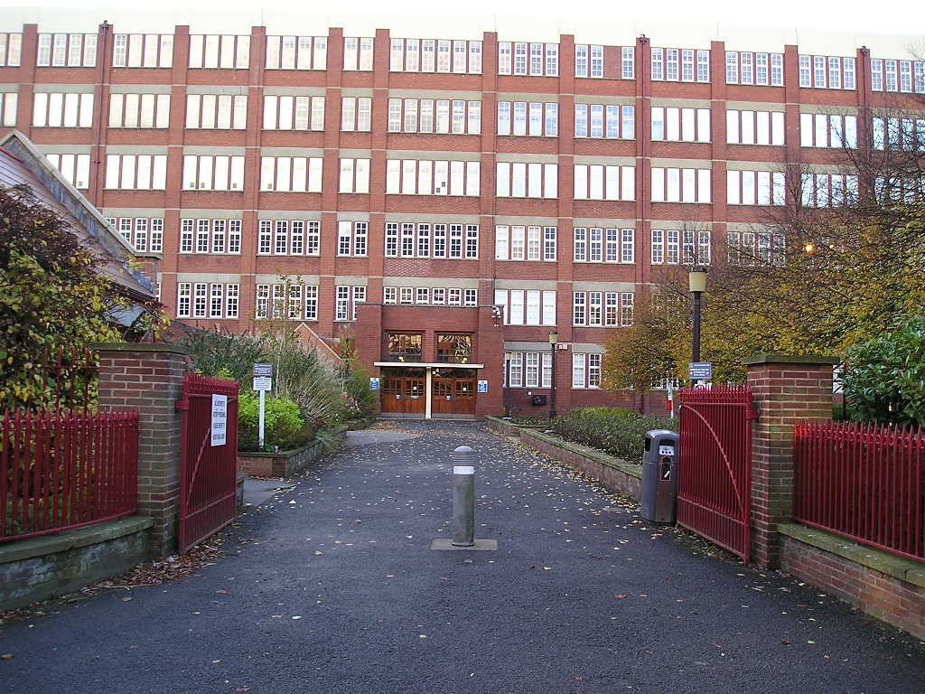 Factory entrance, showing gates and driveway, through garden area