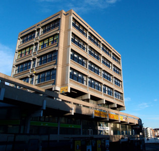 1960s concrete building, against blue sky