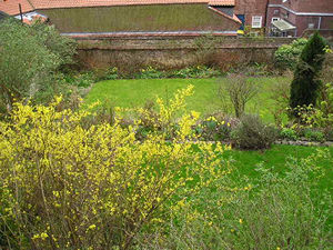 Gardens by the Minster, viewed from the city walls, with spring-flowering shrubs and green lawns