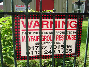 Security firm's sign on front railings