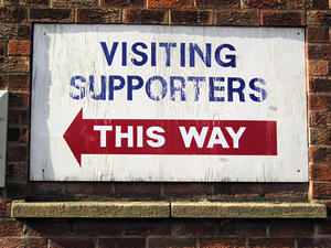 Sign: Visiting supporters – this way