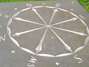 Carving showing compass points, by F Emerson